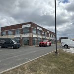 Immeuble de bureaux commercial avec véhicules Doc Électrique dans le stationnement